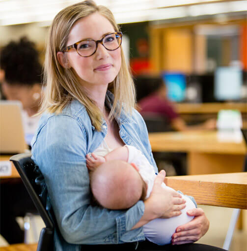 picture of woman smiling and breastfeeding
